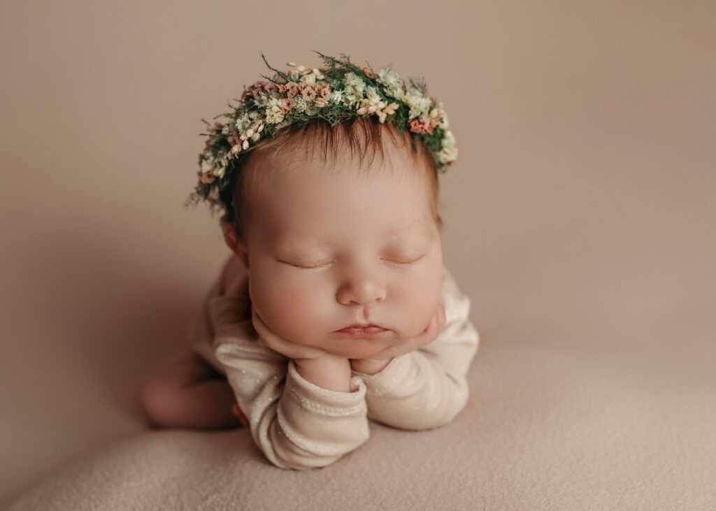 newborn baby girl with flower wreath 