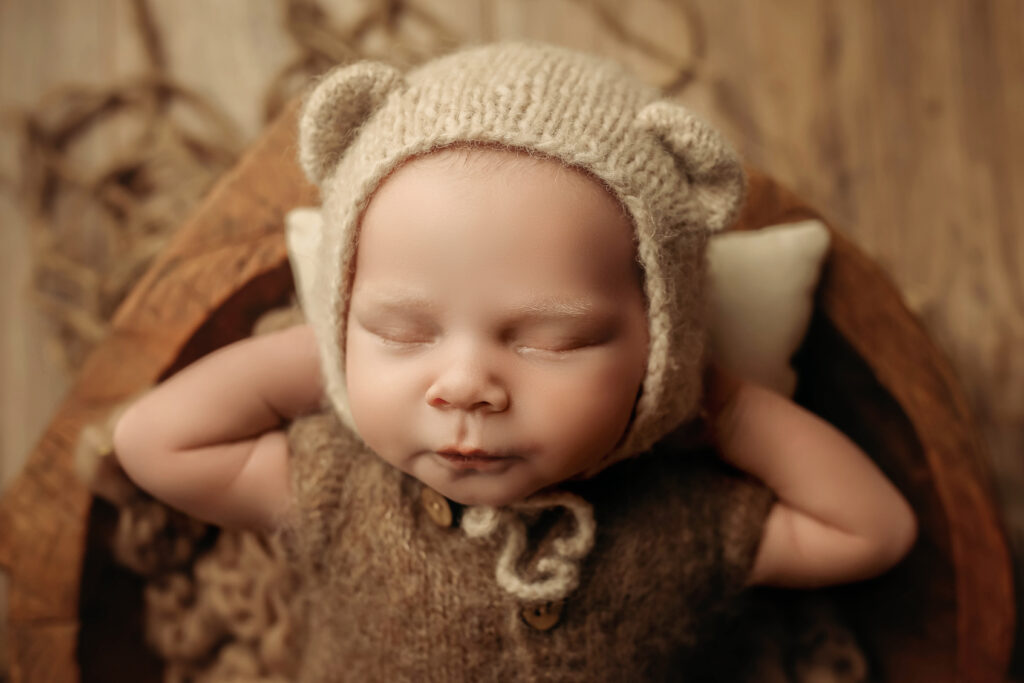 newborn baby boy wearing bear ears