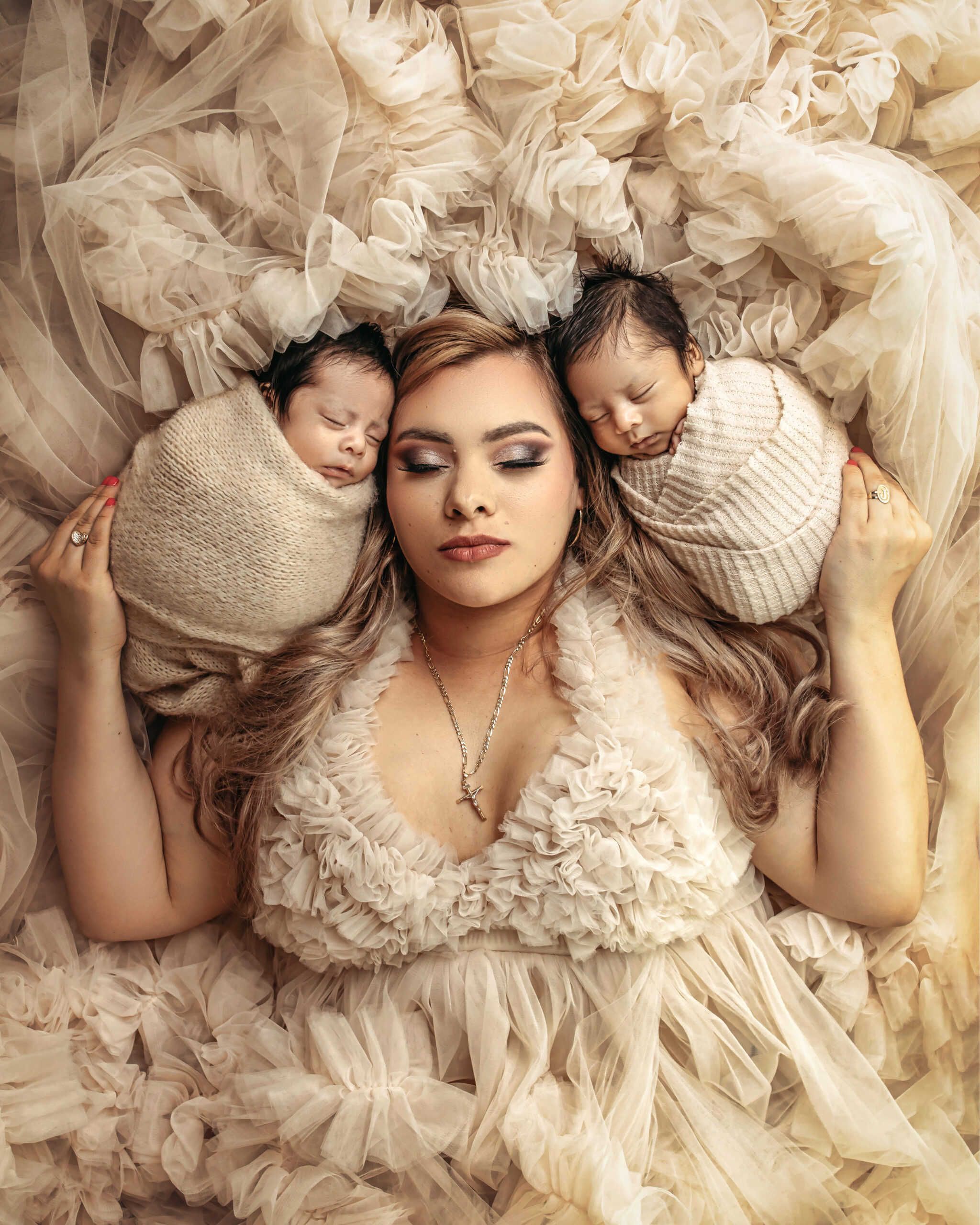 mom with professional hair and makeup and newborn twins
