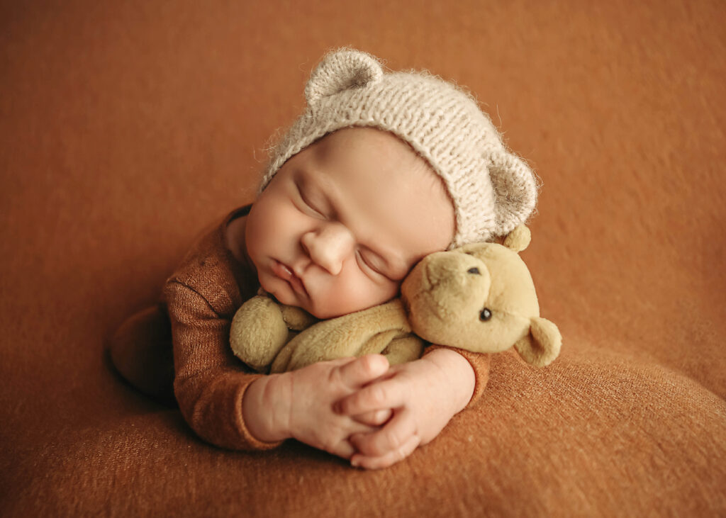 Newborn Baby snuggling a teddy bear. Oklahoma City newborn photographer