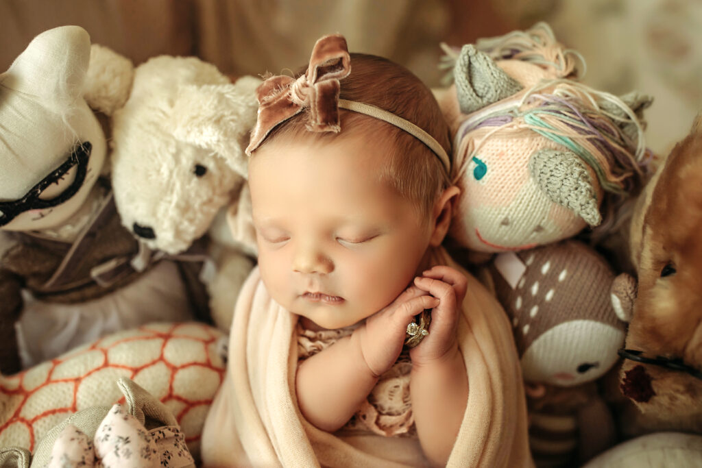 customized newborn photo session

baby with vintage stuffed animals 

baby holding mom's ring