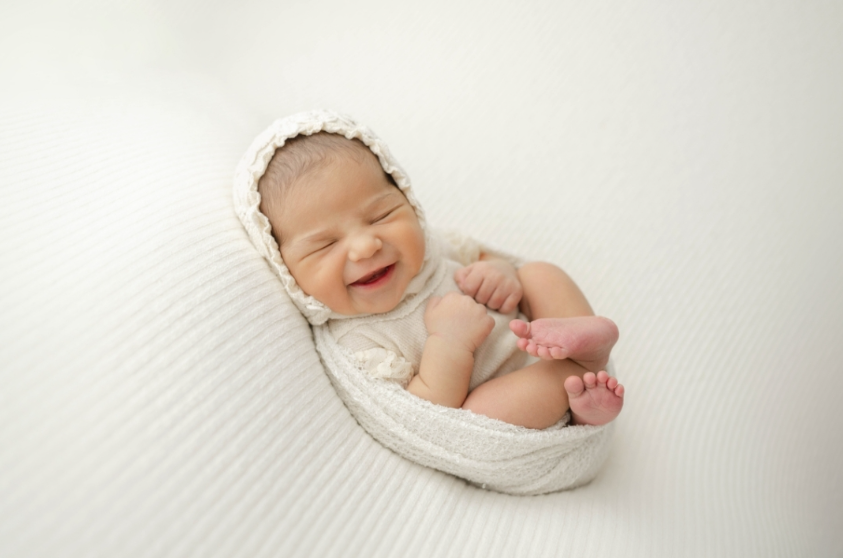 Lacee Smith Photography. Baby posed in all white smiling.