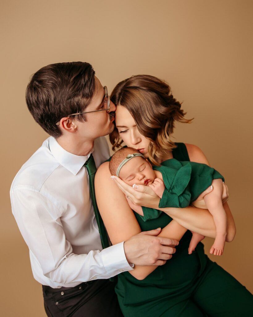 newborn baby with her mother and father 