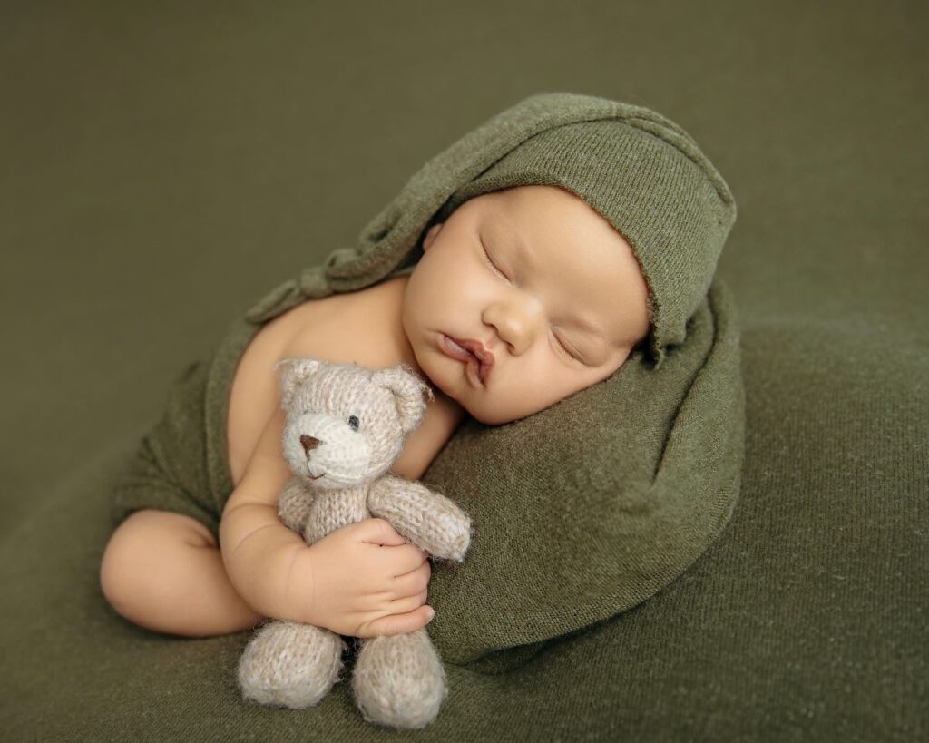 Hospital bag must-haves | Baby cuddling with stuffed bear