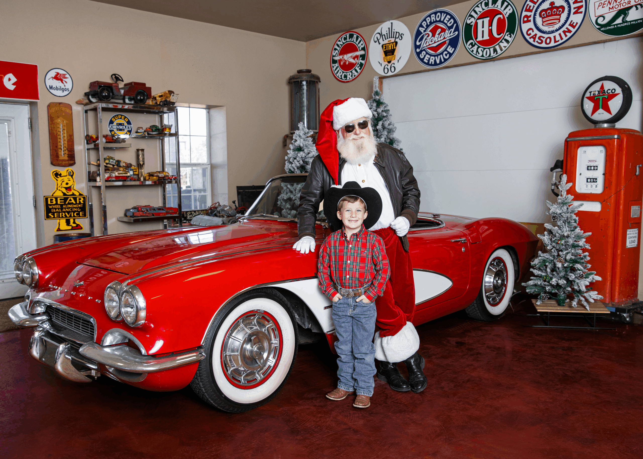 santa and young cowboy next to a corvette in a santa photo mini session in OKC