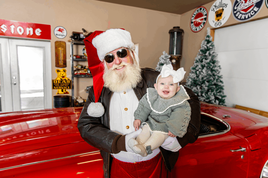 Santa with little girl dressed for christmas in a santa photos session