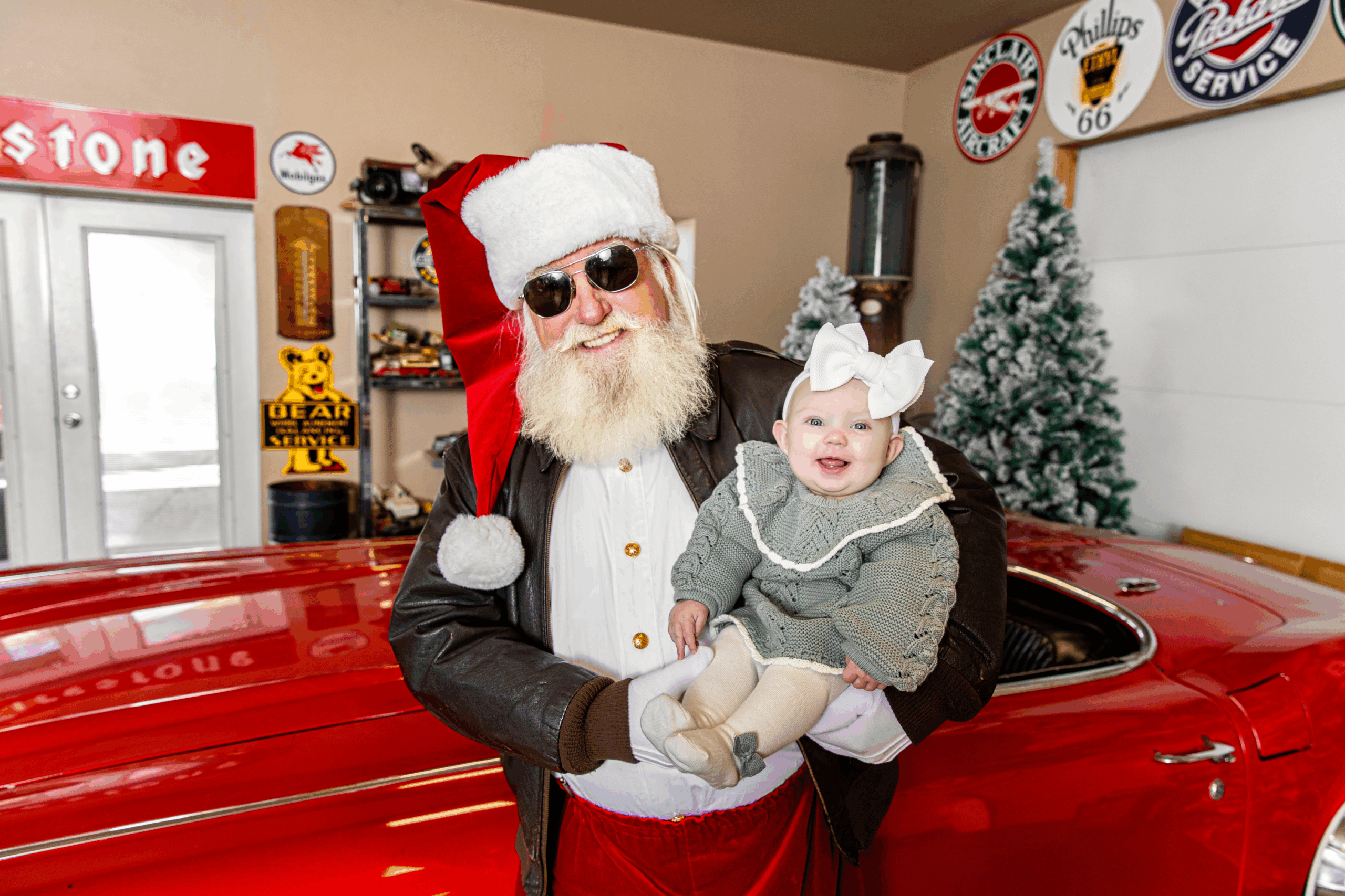 a santa mini session with smiling babygirl in Santa's arms