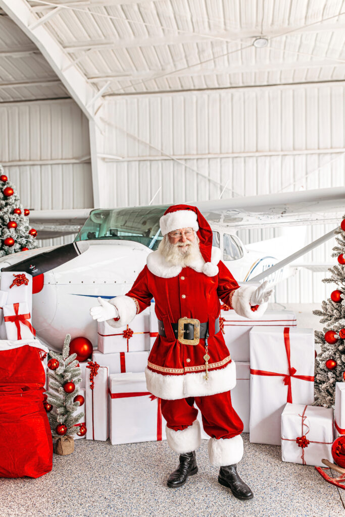 Oklahoma City Santa Photos. Santa posed in front of an airplane at an airport in Oklahoma City.