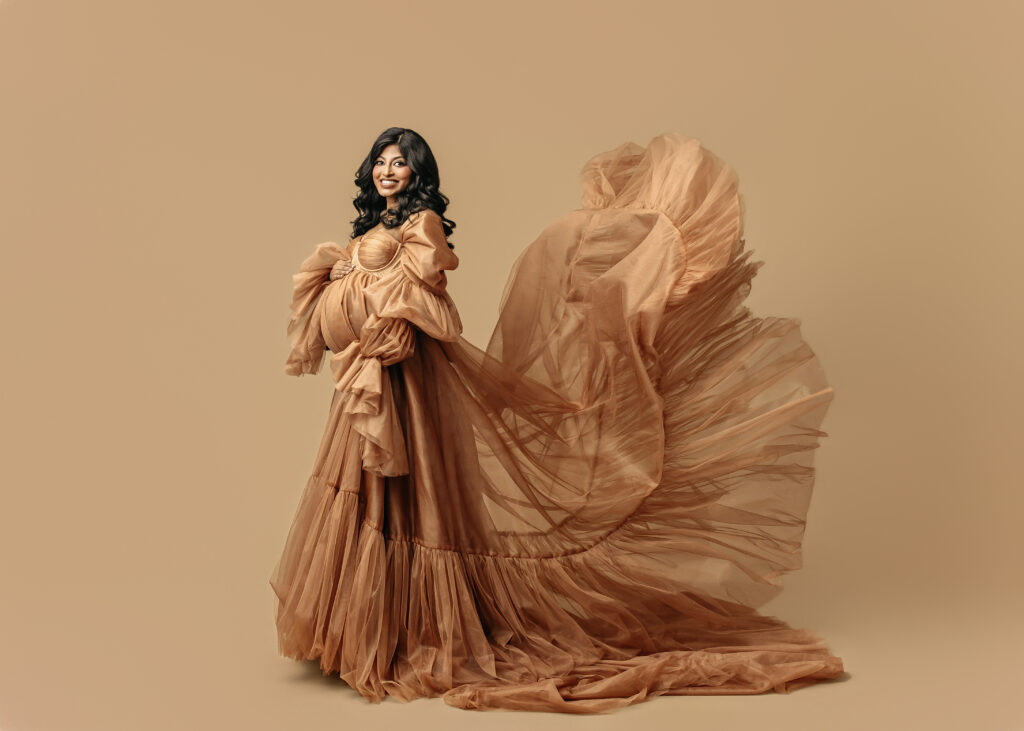 gold dress flowing during maternity photo session in OKC
