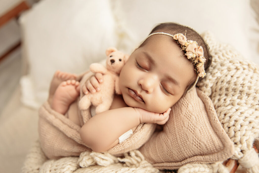A peaceful, resting baby maintaining a safe and regular temperature for a newborn during a luxury Oklahoma City photography session.