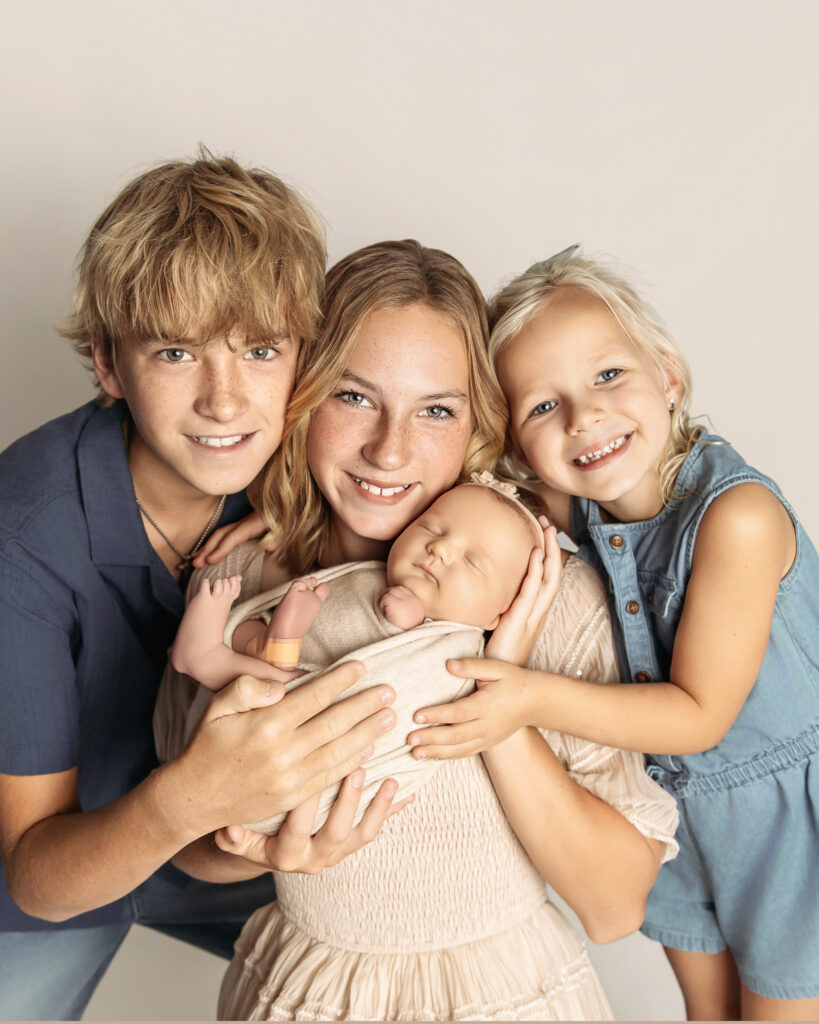 siblings holding newborn baby in family newborn photos in moore, oklahoma